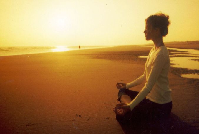 woman-sitting-in-beach-yoga-practice